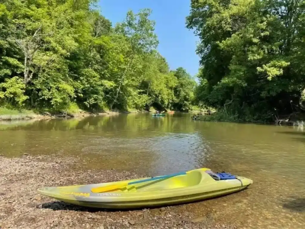Single kayak resting on a gravel bar along the Hocking River