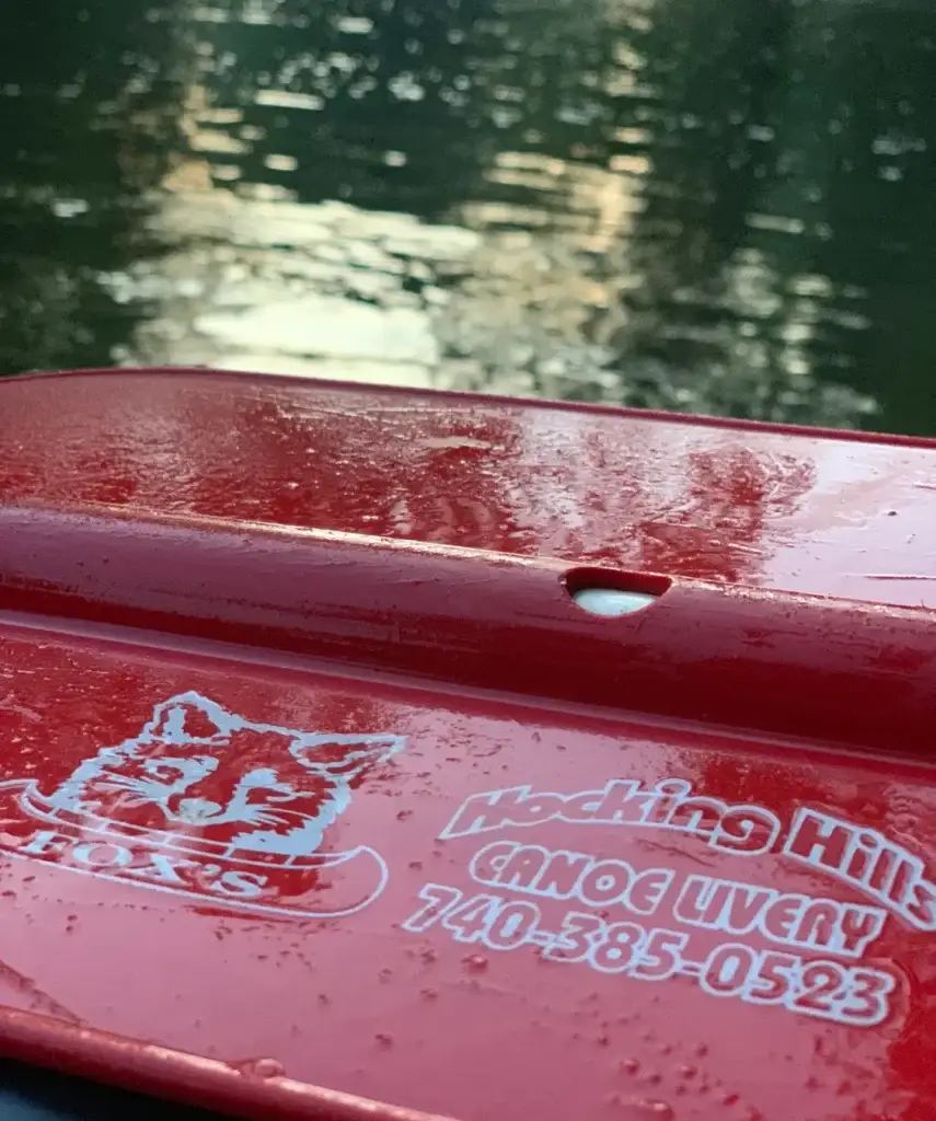 Close-up of a red Hocking Hills Canoe Livery boat on the Hocking River