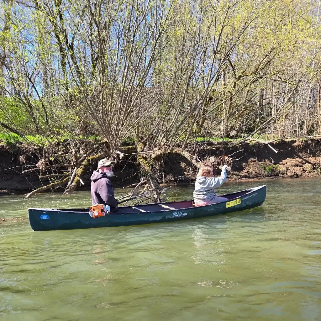 Two paddlers in layers on a quiet, cool-weather stretch of the Hocking River