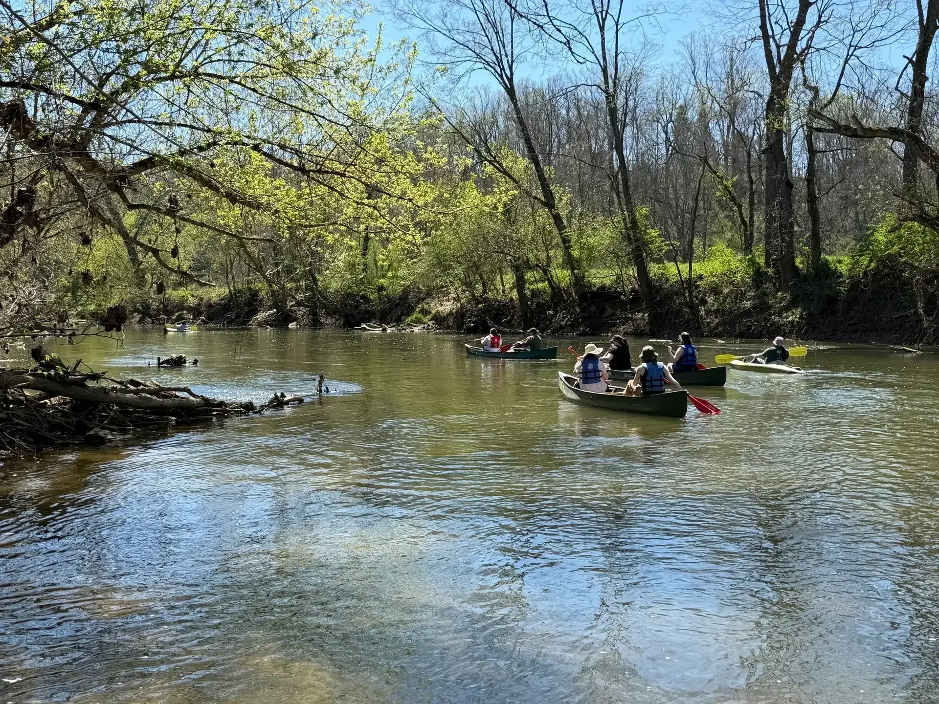 Canoes and kayaks on a calm stretch of the Hocking River on a Natural Rockbridge canoe trip